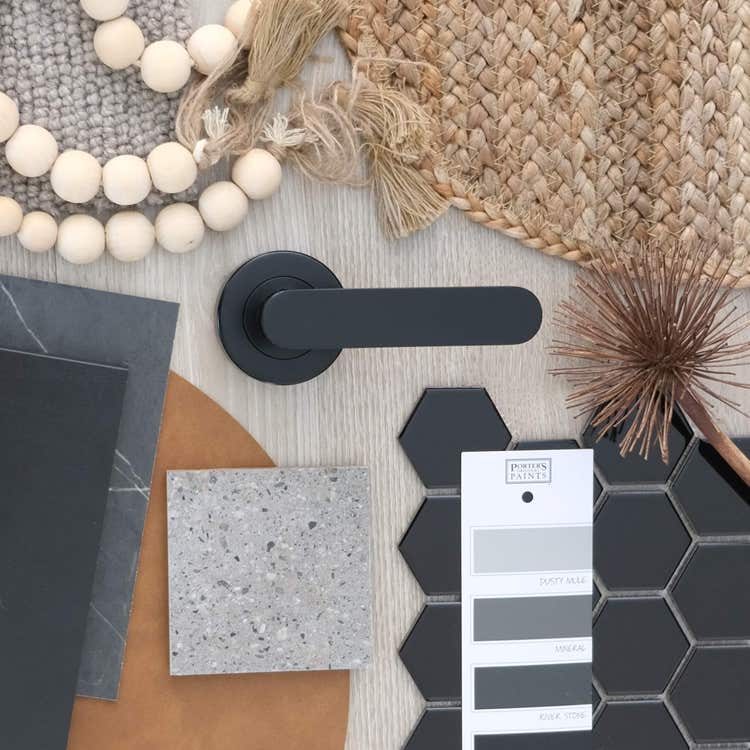 Black door handle with material samples and decor elements